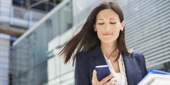 o-WOMEN-IN-BUSINESS-facebook Woman looking at cell phone